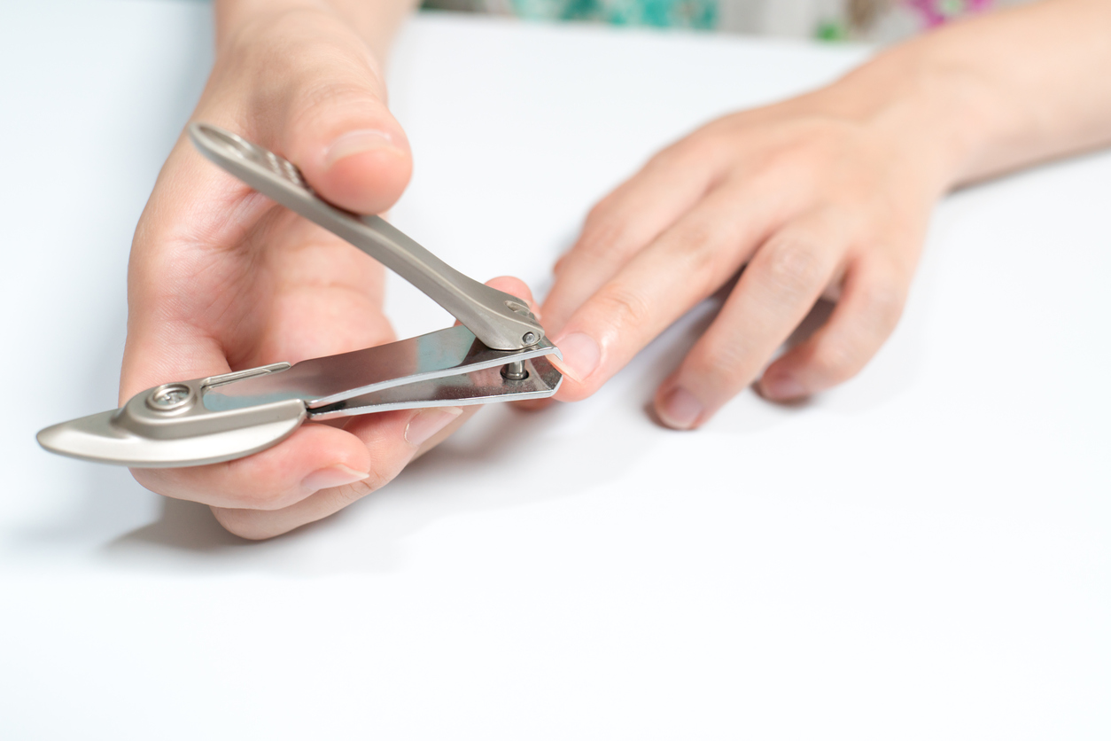 Woman cutting nail.