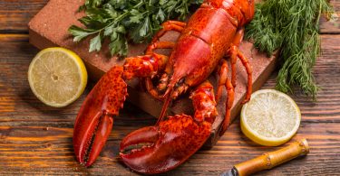 Freshly cooked lobsters with lemon and herbs