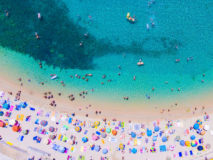 People bathing in the sun at the beach, aerial view