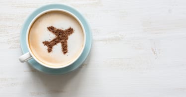 Airplane made of cinnamon in cappuccino , white background