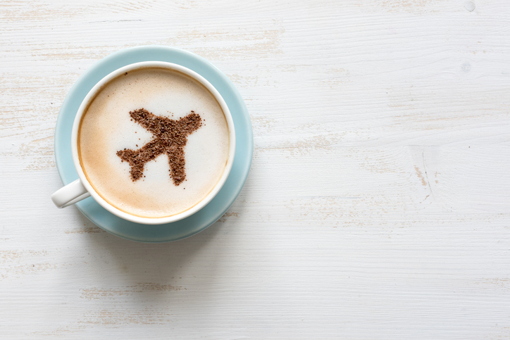 Airplane made of cinnamon in cappuccino , white background