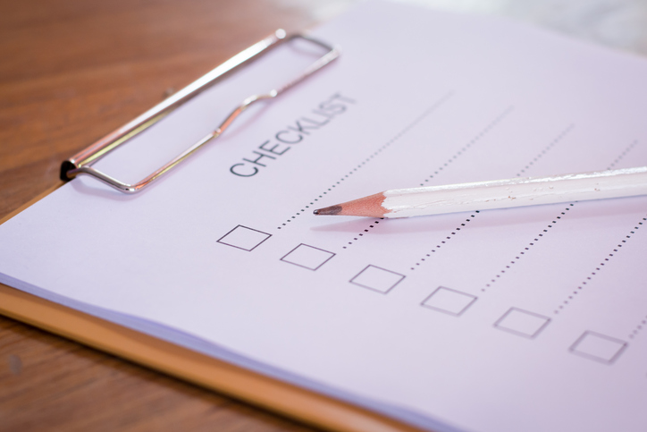 Checklist concept - checklist, paper and a pen