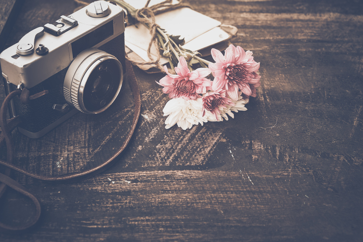 Vintage camera with bouquet of flowers
